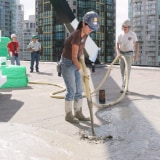 Woman pouring Siplast Lightweight Insulating Concrete at Qube in Canada