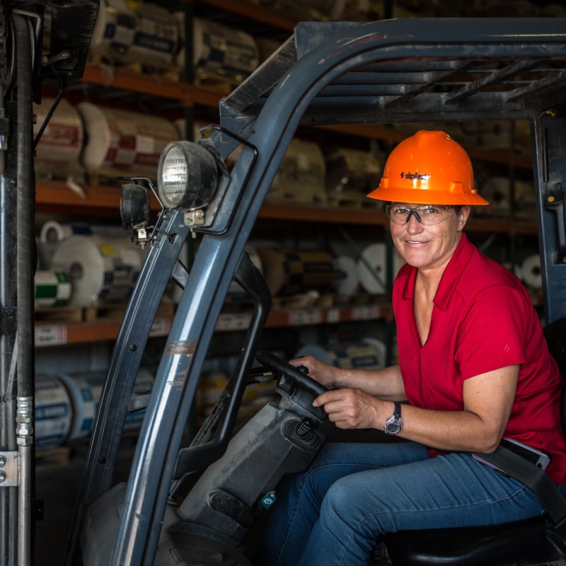 Siplast employee on equipment at Arkadelphia manufacturing plant