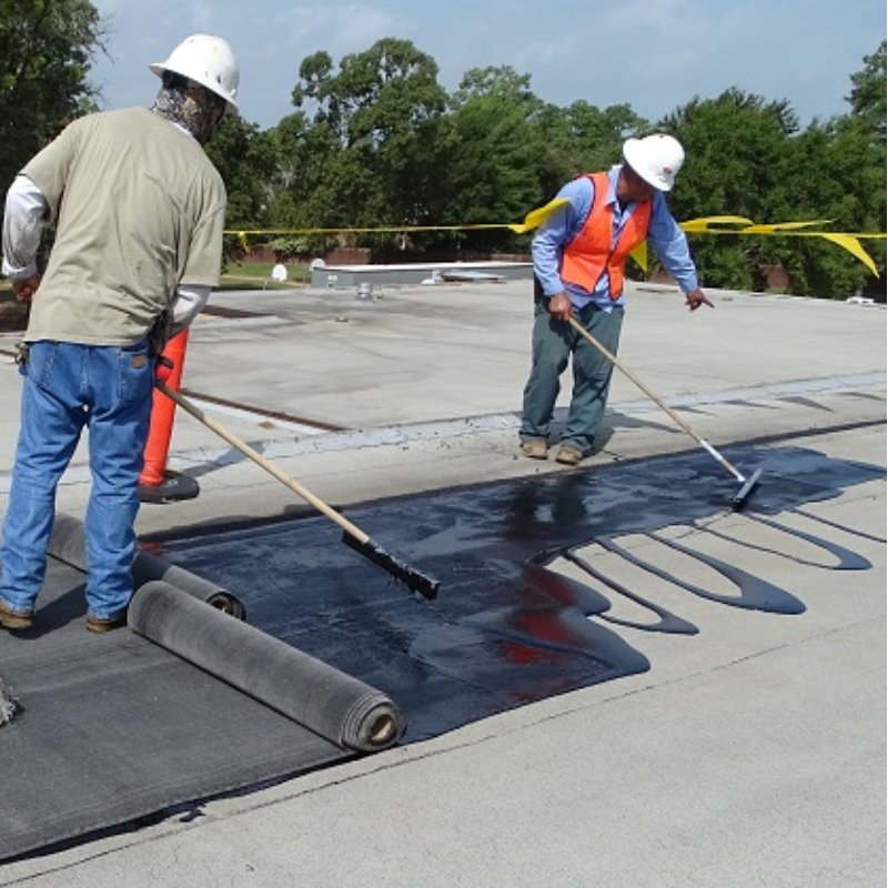 Roofers installing a sbs roofing system on a flat roof