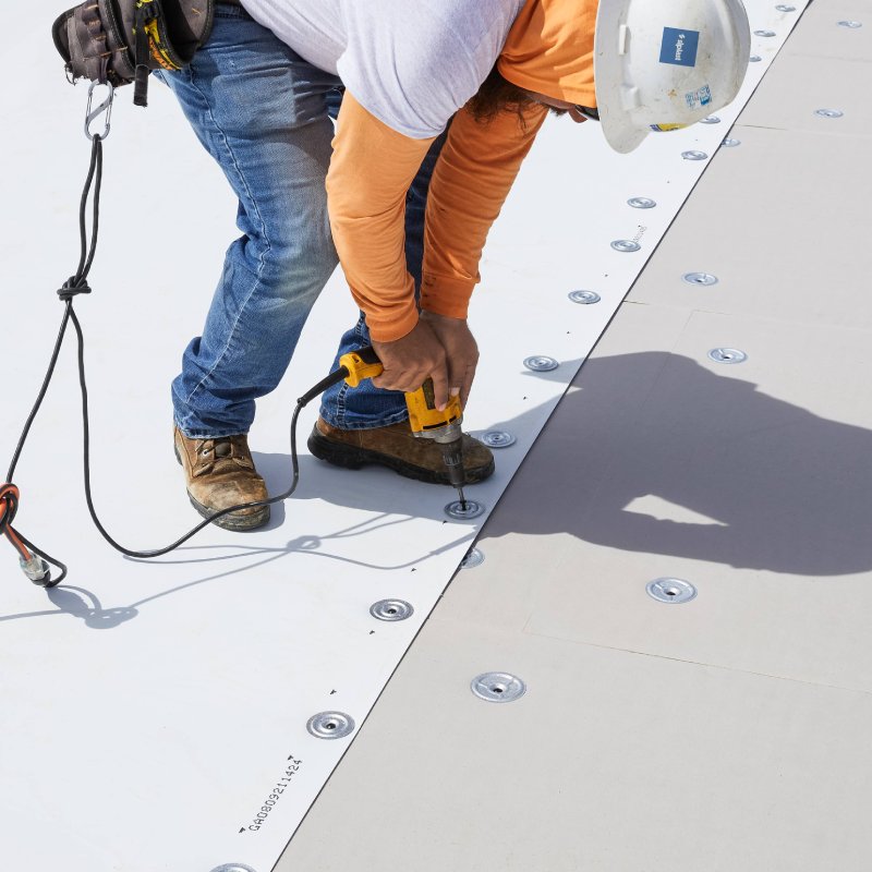 Contractor installing Siplast roofing materials