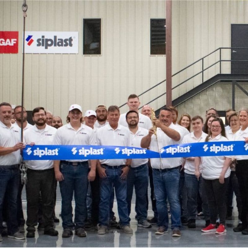 Employees at Siplast ribbon cutting