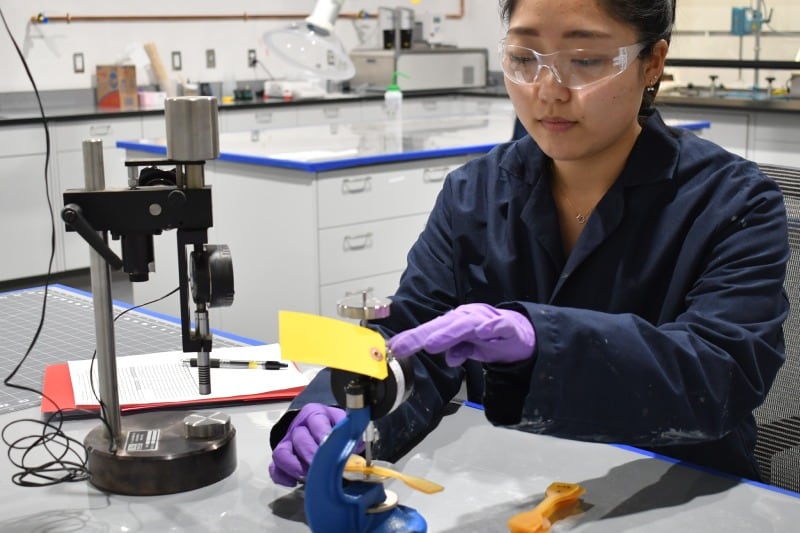 Female scientist performing research at Siplast’s RISE Center