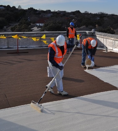 Roofing contractors applying Siplast SBS roofing materials