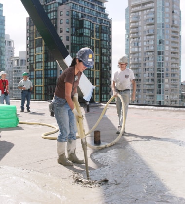 Woman pouring Siplast Lightweight Insulating Concrete at Qube in Canada