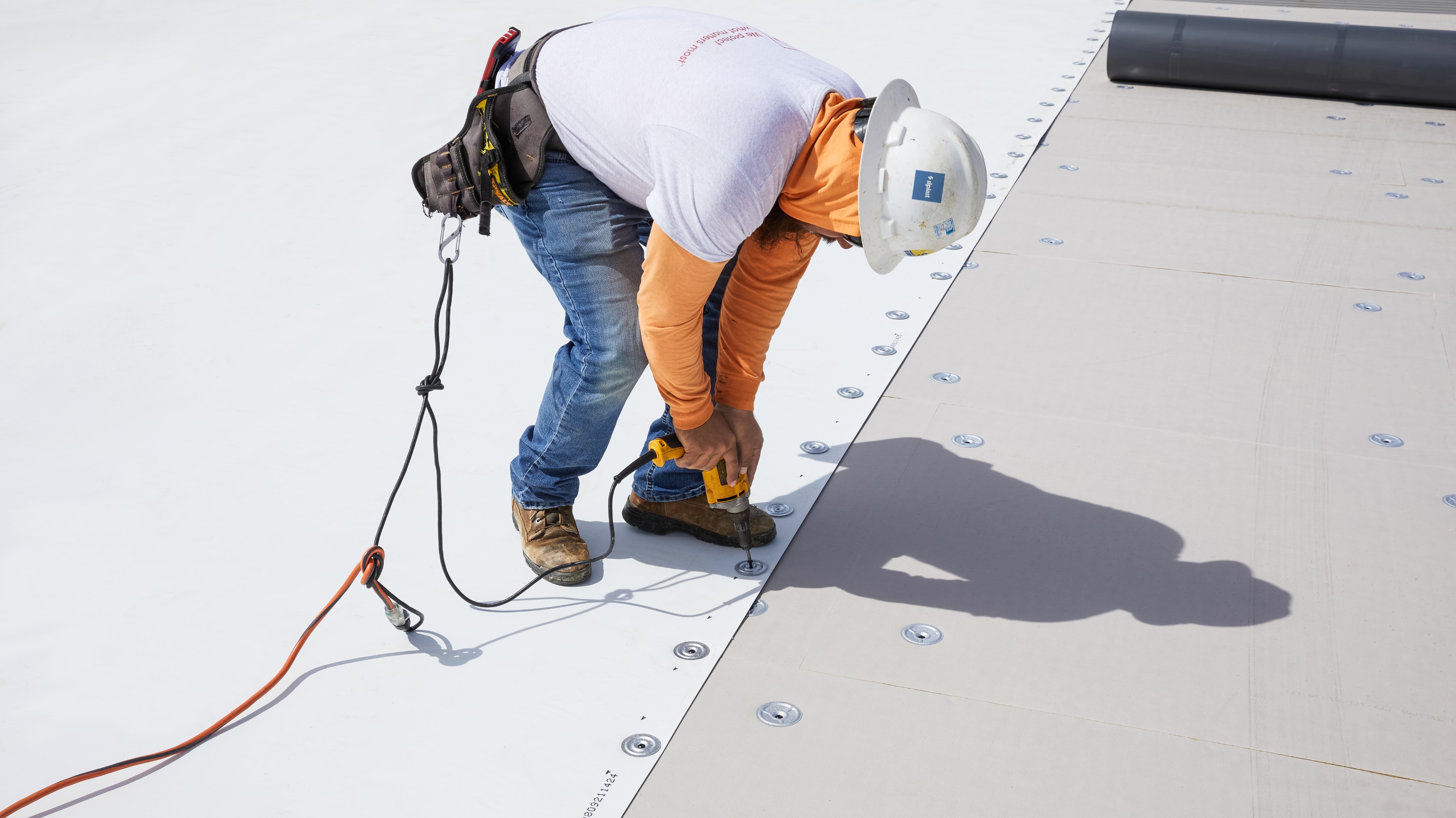 Roofing membrane being mechanically-attached to a commercial roof